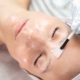 A close-up of a woman receiving a professional collagen treatment at a beauty salon.